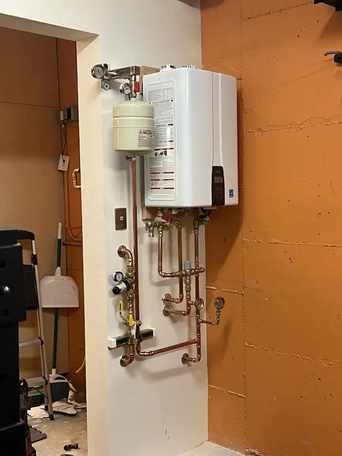 Plumbing technician inspecting water heater connections in Gardnerville